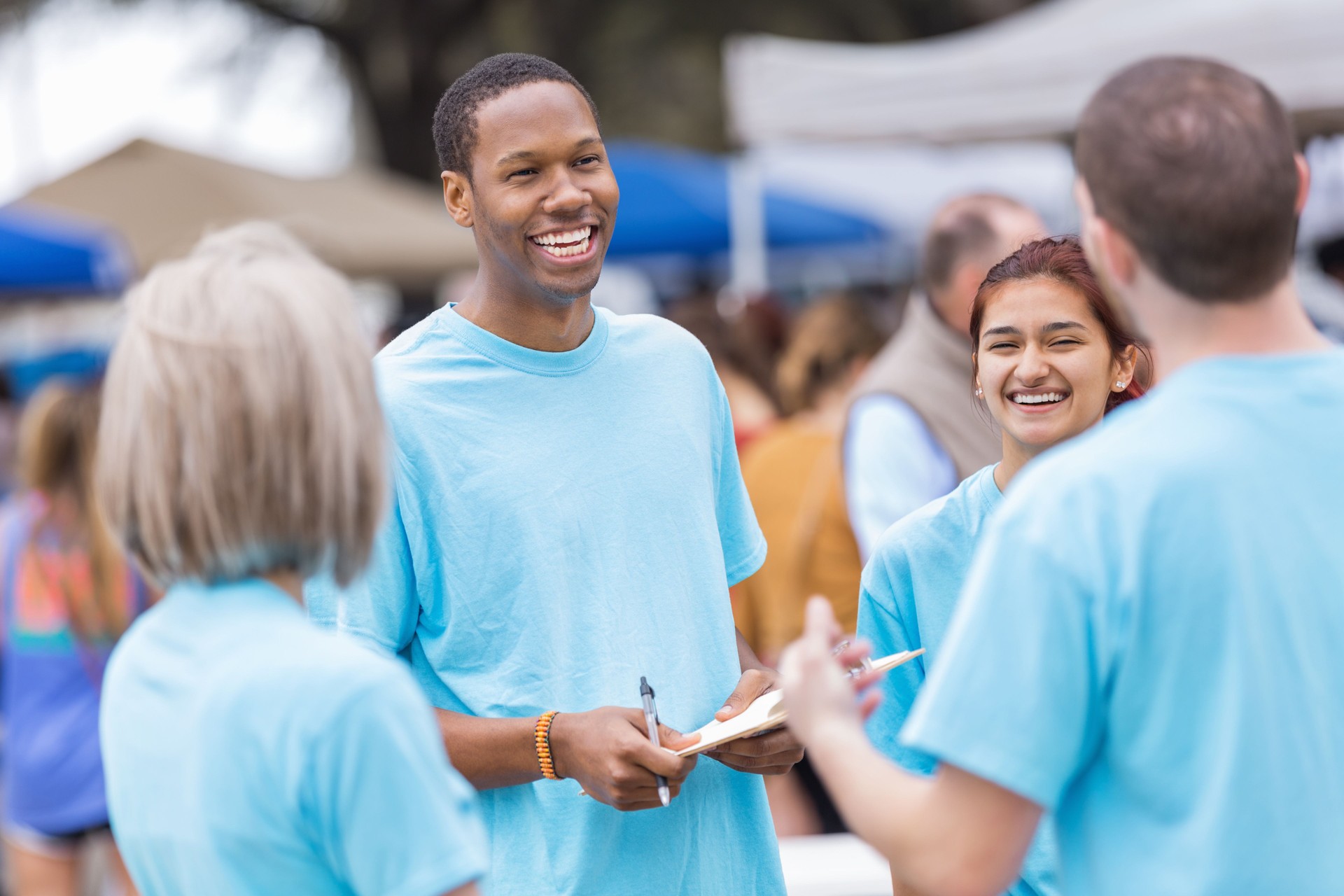 Happy group of people in blue shirts volunteering